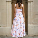 Woman wearing a midi floral dress back view