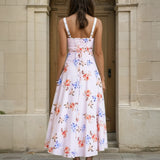 Woman wearing a midi floral dress back view