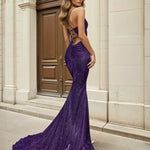 Woman wearing a purple lace up back glitter formal evening gown in front of classical architecture.