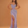 A woman modeling a strapless lavender and silver sequined floor-length gown with a sweetheart neckline, thigh-high slit, and slight train against a warm tan studio backdrop.