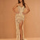 A woman models a floor-length champagne gold sequined gown with a sweetheart neckline, ruched bodice, high thigh slit, and a long draped train against a warm beige studio backdrop.