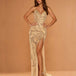 A woman models a floor-length champagne gold sequined gown with a sweetheart neckline, ruched bodice, high thigh slit, and a long draped train against a warm beige studio backdrop.