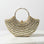 Gold beaded handbag on a marble surface with a white background