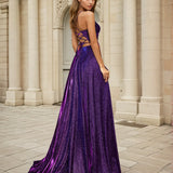 Woman in a purple evening dress formal a-line gown standing in front of classical architecture.