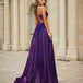 Woman in a purple evening dress formal a-line gown standing in front of classical architecture.