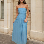 Woman wearing a blue strapless dress 