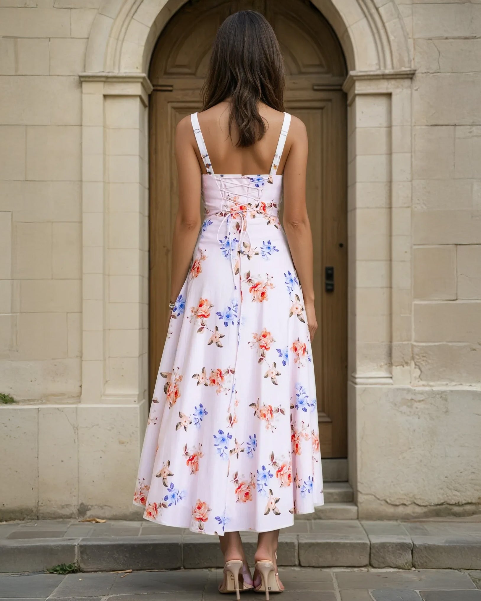 Woman wearing a midi floral dress back view